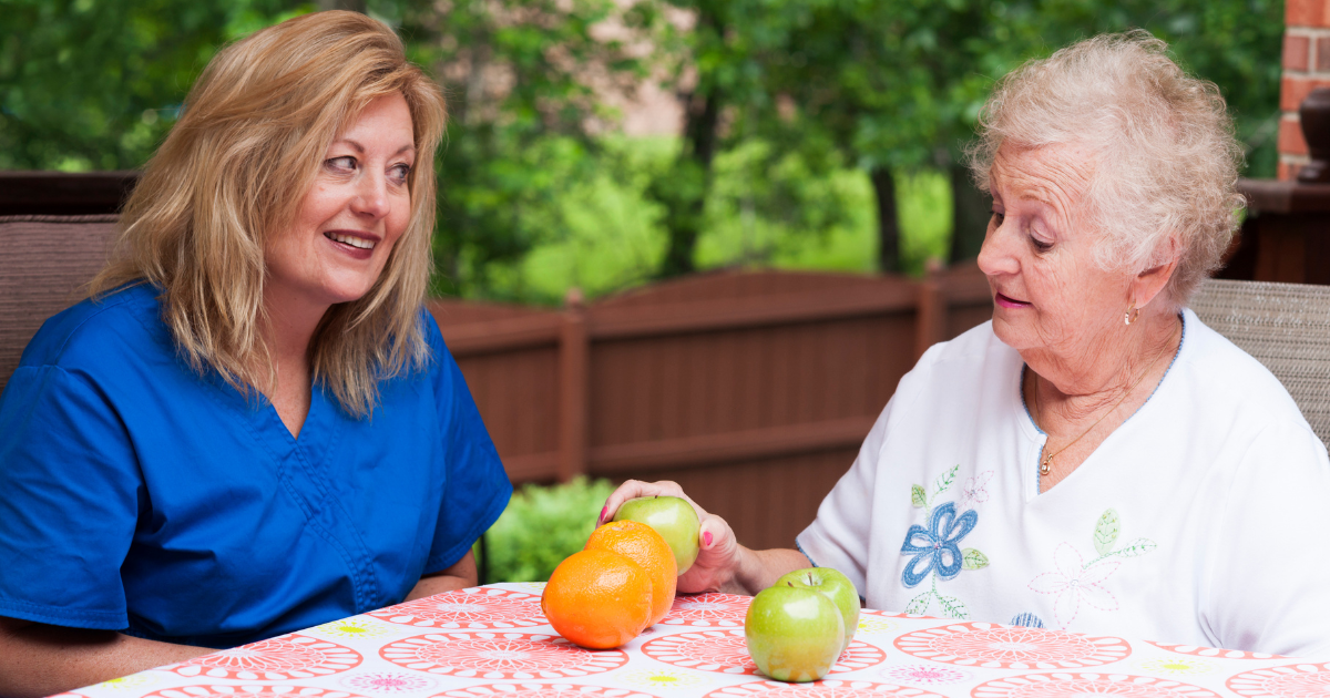 Elderly sitting with caregiver