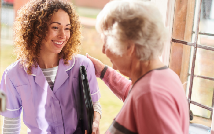 A caregiver enters a senior client's home to provide respite care services.